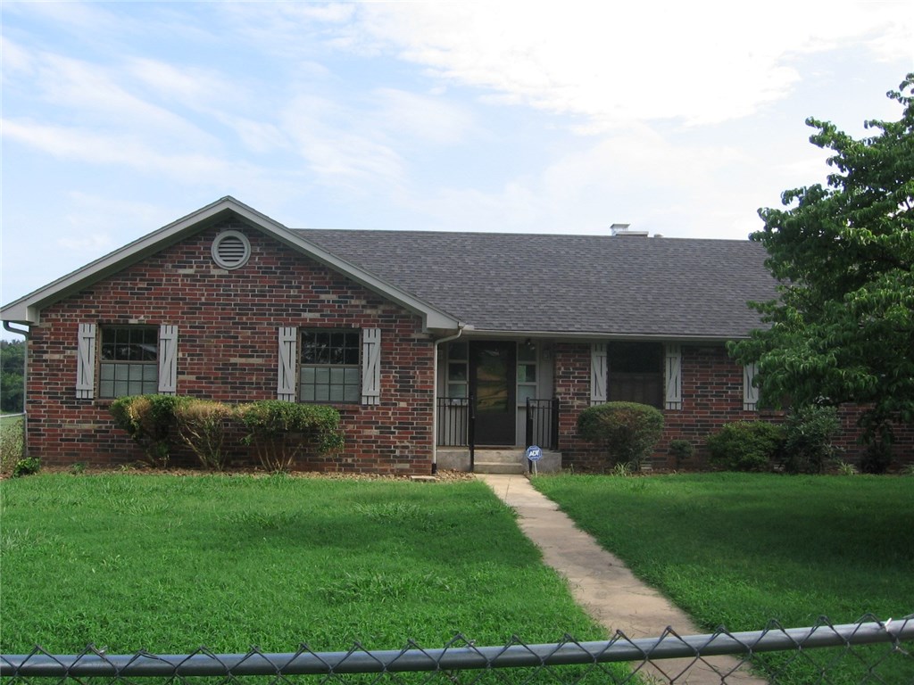 Lovely brick single family home in a rural setting. Just minutes from Springdale & Fayetteville. Master bedroom, 2nd & 3rd bedrooms plus office on main level. Additional bedroom and full bath in basement. Just refinished hardwood floors. Kitchen appliances. Cozy fireplace in living room with a sliding door leading to deck off back of house. Oversized 2-car garage and a chain link fence. Move-in ready! Call today to preview.