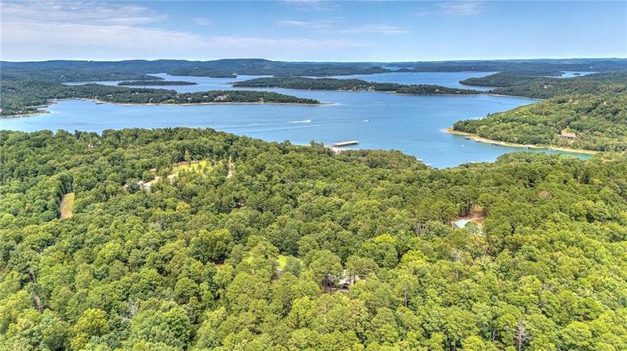 There aren't many properties left like this in Northwest Arkansas.
Tucked into the Beaver Shores neighborhood on nearly an acre of wooded hillside, this 3,096 sq ft log cabin home delivers the kind of privacy and natural beauty that's nearly impossible to find this close to town. Three bedrooms, three baths, multiple living areas, granite counters, walk-in closets, and built-in features throughout — all wrapped in the authentic charm of cabin construction.
You're five minutes from Beaver Lake access, fifteen minutes from Downtown Rogers, and a short drive to War Eagle Mill, Hobbs State Park, and the Karst trail system. The setting feels remote. The commute tells a different story.
Properties like this don't trade often. Don't  miss your opportunity.