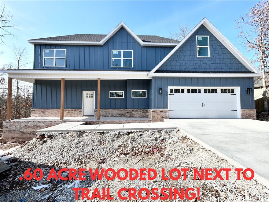 New construction with a bonus room on a .60 acre wooded lot next to a trail crossing and the Lake Windsor boat launch! This stunning property offers the perfect blend of nature and nearby amenities. Step inside to discover a beautiful fireplace, custom cabinets, gas range, and elegant 3 cm quartz countertops. This thoughtfully designed home features 3 spacious bedrooms plus a versatile bonus room, providing ample space for entertainment. The primary bedroom is conveniently located on the main level. Bentonville schools! As an added bonus, this home includes $3,500 in buyer's closing costs when using the builder’s preferred lender!