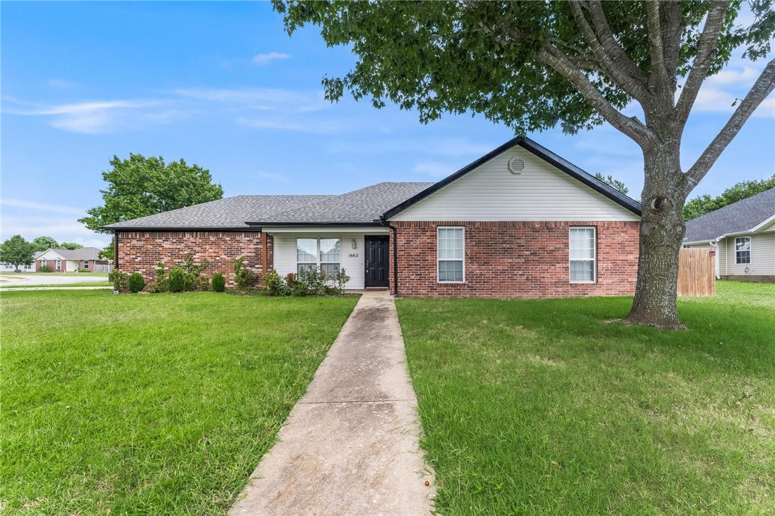This home in Huntclub subdivision sits on a corner lot with a side-entry garage. It has 3 bedrooms and 2 baths. The living room has a corner gas log fireplace and vaulted ceilings. It's next to the bright dining area, back exit, and galley kitchen. There is wine storage above the large fridge space and plenty of storage. Primary bedroom has laminate wood flooring and vaulted ceiling to match the living areas. Outside, enjoy a large yard with privacy fence. This home is close to Lake Wilson Park and Lake Sequoyah Park, and just down the road from Downtown Fayetteville.