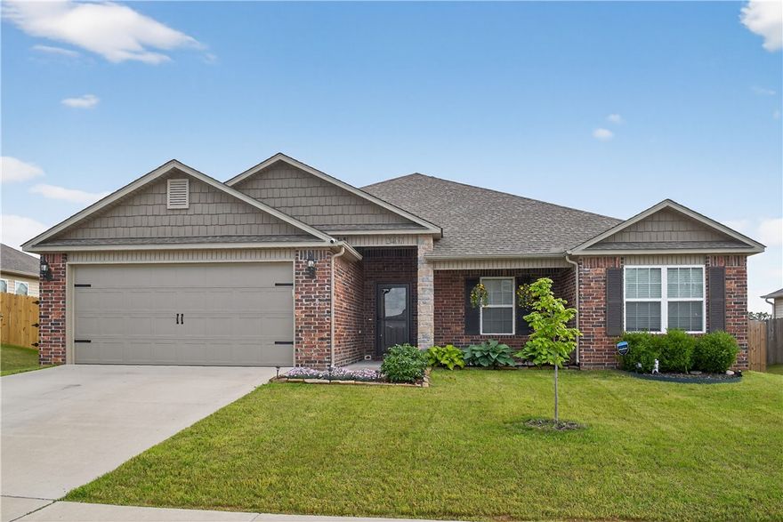 Located in a growing area just minutes from NWA dining, shopping, and I-49. This one-owner home (built 2020) is a beautifully maintained, thoughtfully designed split floorplan features 3 bedrooms, 2 baths, full dining room, & an open living area that balances flow and privacy. The owner’s suite offers a serene retreat, complete w/a full-sized bathroom & large walk-in closet. Generous closet/storage space is strategically positioned throughout the home. Two bedrooms sit in a private hall near a spacious & flexible layout where the kitchen, living, & dining areas meet. The fully equipped kitchen offers a large granite island, plentiful counter space, pantry & SS appliances, LVP floors main living, and high ceilings. Enjoy great curb appeal w/a covered front porch, fabulous outdoor living space w/a covered back patio & custom wood deck perfect for entertaining. Spacious backyard w/wood privacy fence. Existing transferable 2-10 warranty. Less Than 2 miles from Janie Darr elementary & the new Mt Hebron activity park