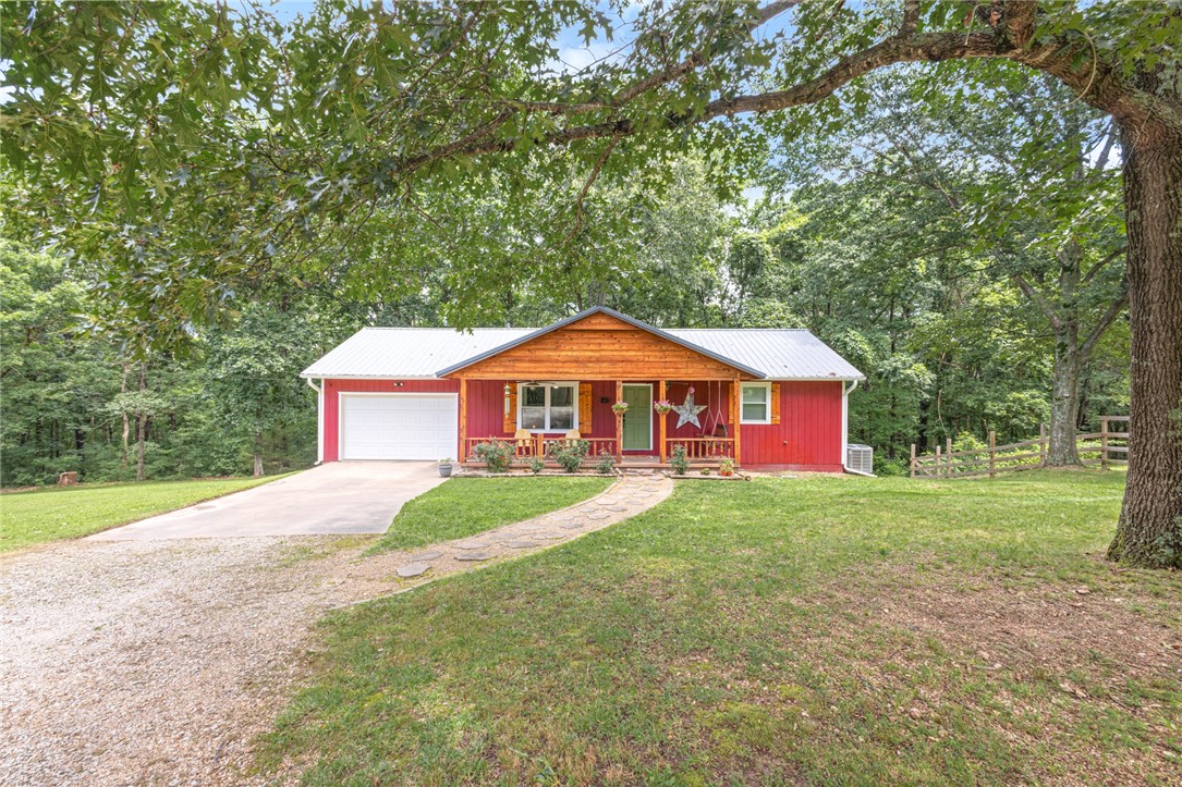 ***$10,000 Buyer Concession! TWO HOMES on over 11 acres in the heart of NWA! This peaceful, beautiful hobby farm sits on the boarder of Pea Ridge and Bella Vista, bikeable to the north Back 40 Mountain Bike Trail and less than 15 minutes to I-49 Bentonville/Bella Vista exchange! With minimal building restrictions, the development opportunity on this acreage is endless! Main home is fully upgraded offering 3B / 2.5B, NO carpet, oversized laundry/pantry/mud room, large downstairs bonus/rec room and plenty of outdoor relaxation and entertainment options with a covered front porch, covered back deck and patio. Guest Home is 500+sf of open floor plan studio space with private full bathroom, laundry, walk in closet and garage. Approximately 2+/- acres fenced for livestock. Recent upgrades: Well pump, control box and pressure tank replaced 2022. Guest home roof replaced 2022. Main home renovations 2021. Main home windows new in 2019.