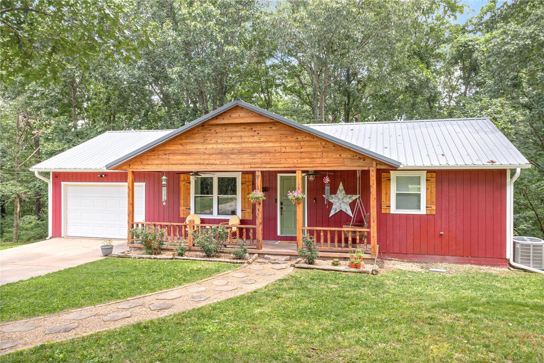TWO HOMES on over 11 acres in the heart of NWA! This peaceful, beautiful hobby farm sits on the boarder of Pea Ridge and Bella Vista, bikeable to the north Back 40 Mountain Bike Trail and less than 12 miles to downtown Bentonville! With minimal building restrictions, the development opportunity on this acreage is endless! Main home is fully upgraded offering 3B / 2.5B, NO carpet, oversized laundry/pantry/mud room, large downstairs bonus/rec room and plenty of outdoor relaxation and entertainment options with a covered front porch, covered back deck and patio. Guest Home is 500+sf of open floor plan studio space with private full bathroom, laundry, walk in closet and garage. Approximately 2+/- acres fenced for livestock. Recent upgrades: Well pump, control box and pressure tank replaced 2022. Guest home roof replaced 2022. Main home renovations 2021. Main home windows new in 2019.