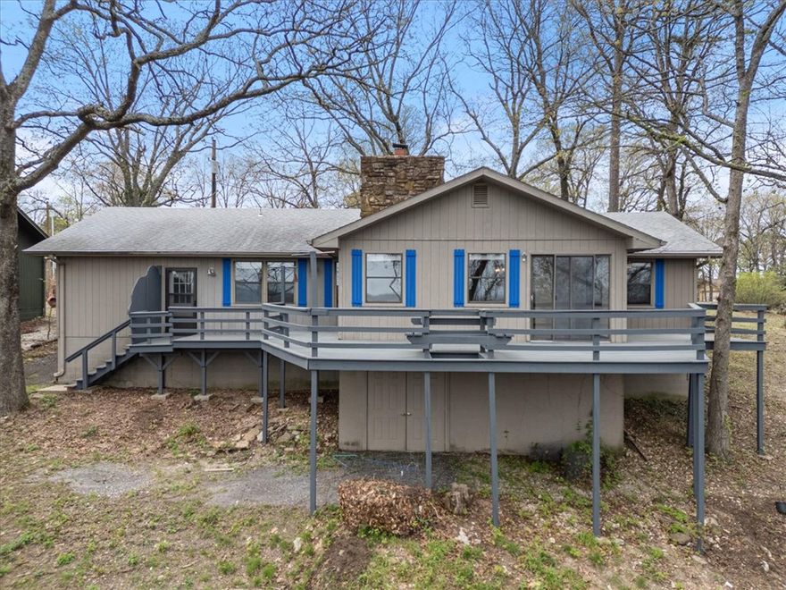 Between the beautifully cultivated gardens in the front and the breathtaking views from the 600 sq. ft. of deck off the back sunroom there is a superbly laid out, split floor plan, home that is perfect for single family or co-living situations and is absolutely move in ready. This home is great for full timers, nightly or short term rentals or simply an affordable second home that sits just minutes from the Holiday Island Marina and Table Rock Lake. Resting on a ridge line in the Ozark mountains, adjacent to the 18 hole golf course there are ample ways to spend your days. Homeowner just had the deck and shutters painted as well as several interior rooms. The carpets in both bedrooms were professionally cleaned just prior to listing. This home sits on a very quiet and cohesive cul-de-sac. Most neighbors have been here for years, good neighbors can certainly make a huge difference in so many ways! You will be just 10 minutes from Eureka, 45 minutes from Branson MO. and about the same distance to downtown Bentonville.