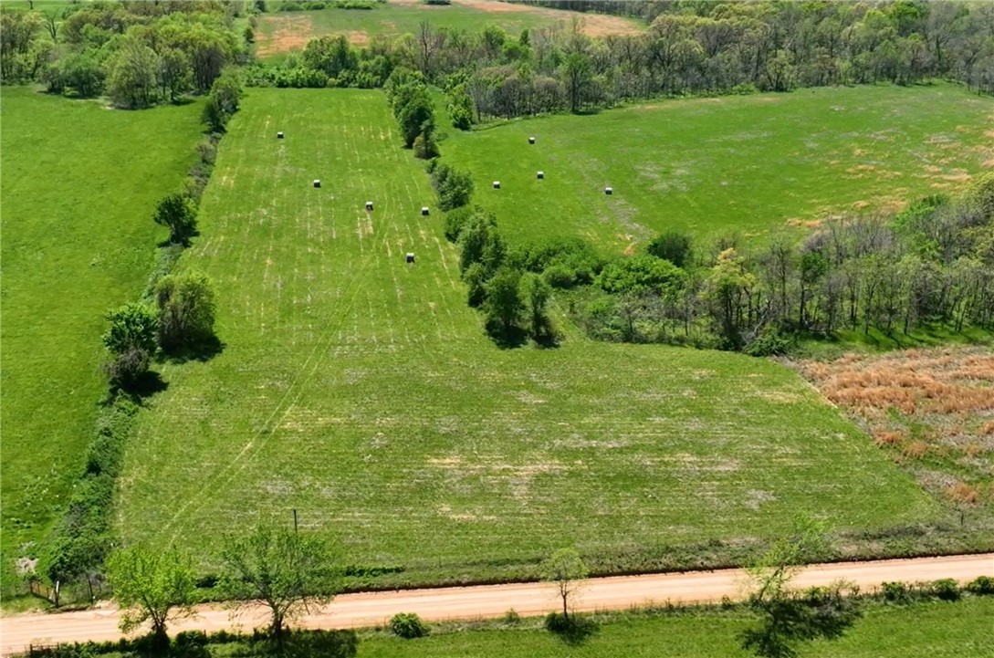 This nearly 10-acre tract has had covenants removed and is the perfect canvas for your dream home, mini-estate, or even a small-scale development. Ideally situated just 2 miles from Bentonville West High School and Gamble Elementary, the property offers that “away from it all” feel without sacrificing convenience. You’re within 15 minutes of Bentonville, XNA, Rogers, and Walmart Headquarters, with quick access to highways 279, 102, 72, and I-49. The land itself is mostly level and open, giving you flexibility and multiple build sites to choose from. Whether you envision a private residence with room for a shop, barn, or hobby farm, or you’re considering subdividing for several homes, this property makes it possible. Electric and city water are already at the street, helping streamline the build process. With strong growth all around and demand for new housing at an all-time high in Northwest Arkansas, this tract not only offers a beautiful place to live, but also a smart investment in future development.