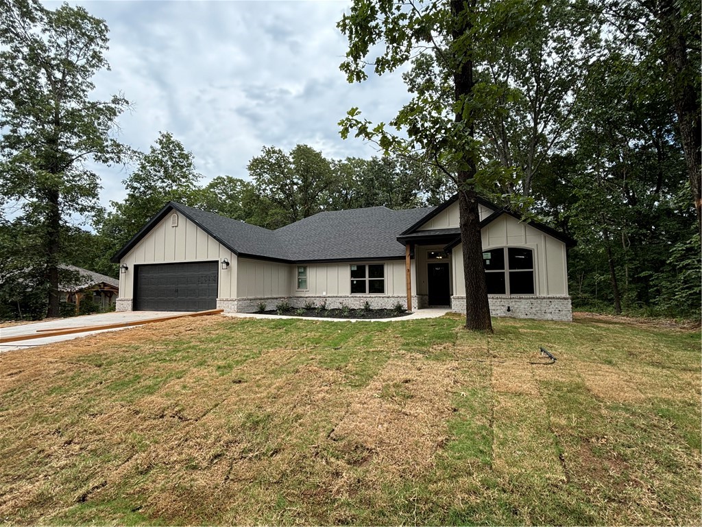 Brand new Bella Vista Beauty sitting on a flat lot in Bentonville School district! 2 bedroom + flex room/2 bath home featuring the builders most popular plan including an open concept with split bedrooms. Boasting lots of natural light, high-end quality finishes: hardwood floors in living and dining area, gas log fireplace, granite countertops, pantry & custom cabinets. Spacious primary suite has a spa like bath with double vanities, custom tile shower & separate free-standing tub. Primary closet connects to laundry room. Enjoy time on the covered deck that overlooks flat yard. Generac transfer switch already installed. $0 down payment, 100% financing, rural development loan available.