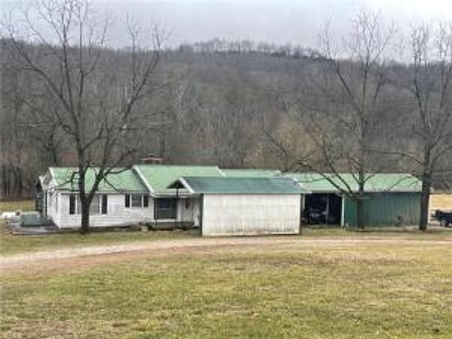 3-bedroom 2 bath home situated on 7 acres m/l. This property is located along Hwy 412 in the Dry Fork community. This property would make a great mini farm or starter home. There is a large pole barn behind the house that could be enclosed to make a nice shop area or a barn for livestock. The home could use a little TLC to make it your own. The possibilities are endless for this property. The acreage is approximate.