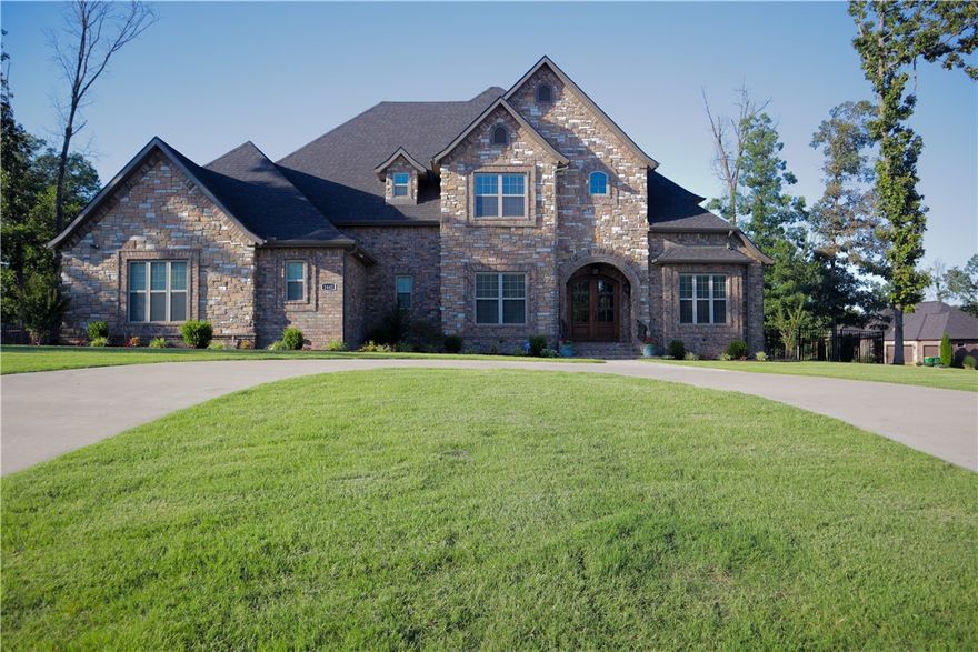 Custom home in the coveted Versailles neighborhood with a rare 1 acre flat, fenced lot! The circular drive and interior are just as impressive and will make you fall in love with its well-planned layout with high-end upgrades throughout. Your inner chef will appreciate the professional-grade Thermador appliances, perfect for entertaining or family meals. Authentic, 1 1/2' hand-scraped hardwoods on the lower level, stairway & landing are timeless, durable, and beautiful. Upstairs boasts 4 more bedrooms, each with its own ensuite bath.  This home has great indoor space, including a formal dining and formal living room, 5 bedrooms plus great outdoor space with unlimited potential.  Make this your home today!