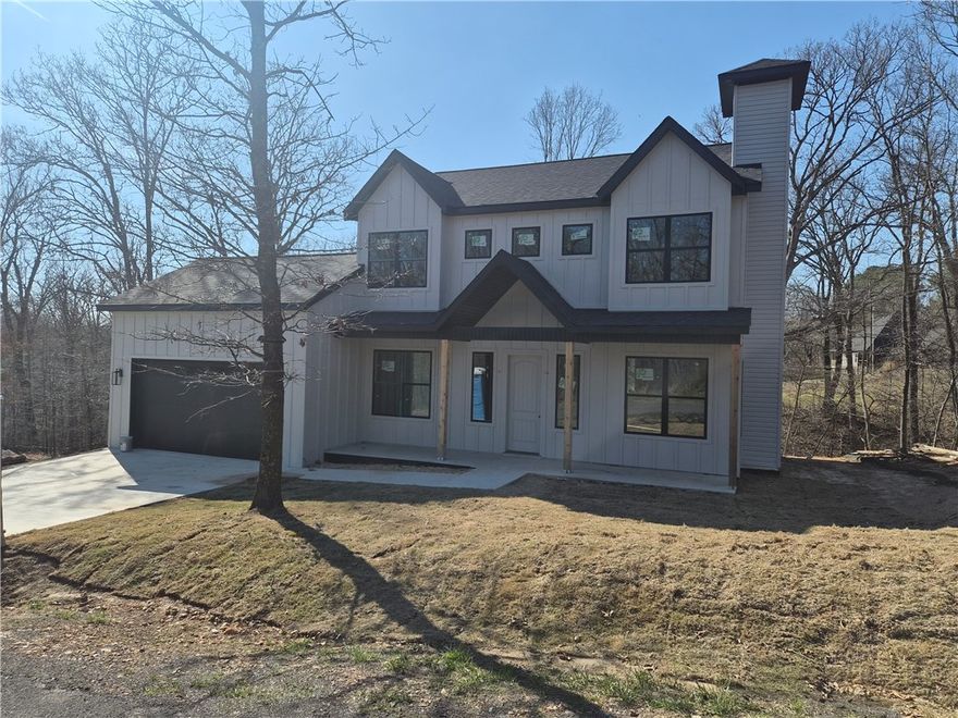 New Construction in a Private Wooded Setting

Welcome to 6 Orchiltree Ln, a thoughtfully designed new construction home in Bella Vista. This modern farmhouse features board and batten siding, dark accents, and a covered front porch with great curb appeal.

Inside, you’ll find an open-concept layout with a spacious living area, large windows for natural light, and a fireplace feature wall. The design flows seamlessly into the kitchen and dining area, ideal for everyday living and entertaining. Durable, stylish flooring runs throughout the main areas.

Enjoy the elevated lot and private wooded setting from the back deck overlooking a natural ravine—one of the standout features of this home.

Additional highlights include a 2-car garage and modern finishes throughout.
Home is currently under construction, offering a great opportunity to get in early. Located near Bella Vista amenities including trails, lakes, and golf.