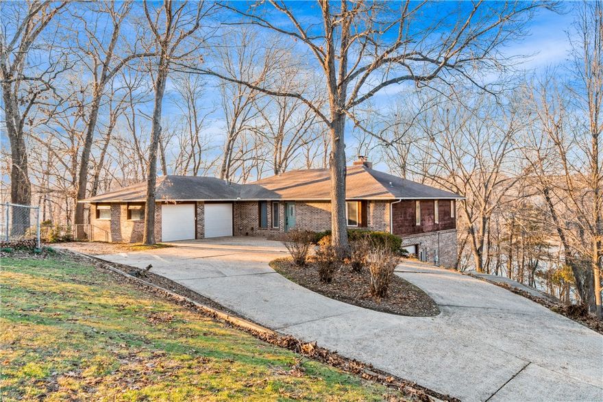 This beautiful 4-bedroom, 3-bath Lakefront home offers a prime spot on Beaver Lake, complete with a boat slip and a jet-ski slip, and is conveniently located less than 10 minutes from downtown Rogers. Enjoy an open floor plan with abundant natural light throughout, plus a finished walk-out basement featuring two bedrooms, a living area, and a workshop. The kitchen and dining area both overlook the lake, making every meal feel like a getaway. The primary bedroom boasts a sitting area with a stunning lake view, a walk-in closet, and an exceptional view of the lake. Access the dock with ease, only a short walk away. This lake home is a dream!