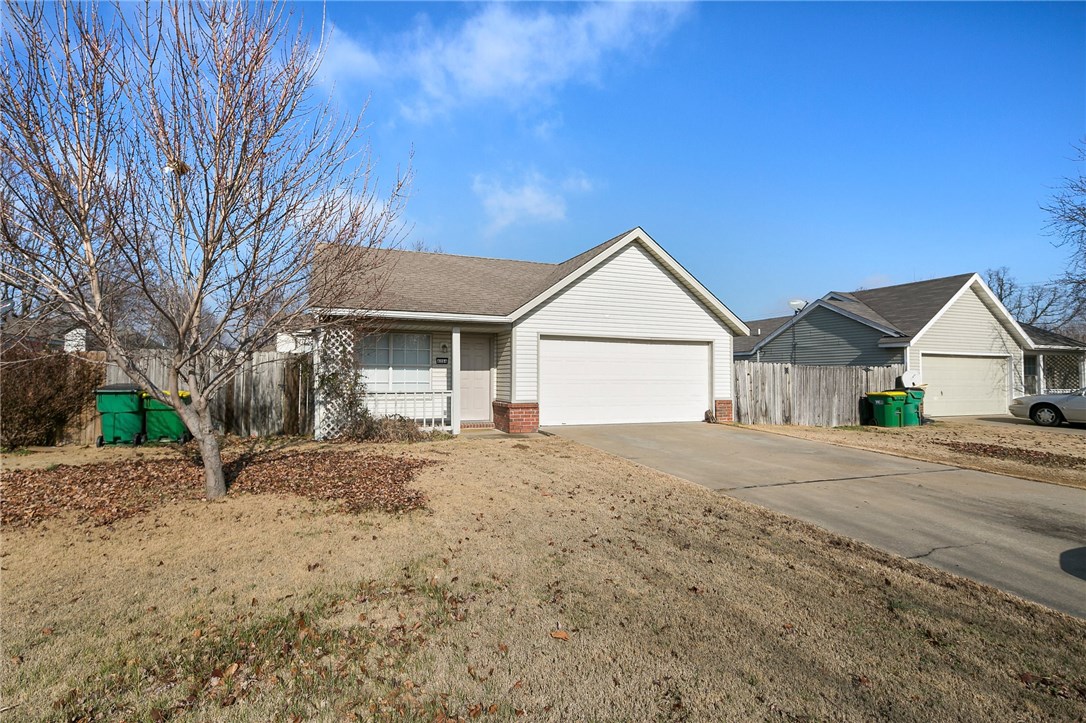 Charming Springdale home with plenty of space to play under the trees in the fenced back yard. You'll enjoy 4 spacious bedrooms with plenty of closet space, a cozy living area, and galley eat-in kitchen with white cabinets and dark countertops. It has a nice flowing floor plan with lots of light, including a bright bay window overlooking the yard from the dining area, making the home feel really open. Relax during cool Arkansas evenings on the covered front porch while enjoying the sounds of your new friendly Vineyard neighborhood. You're in a great location with easy access to I49 and 10 miles to Fayetteville. Garage has been converted into the 4th bedroom. Perfect starter home or rental for student.