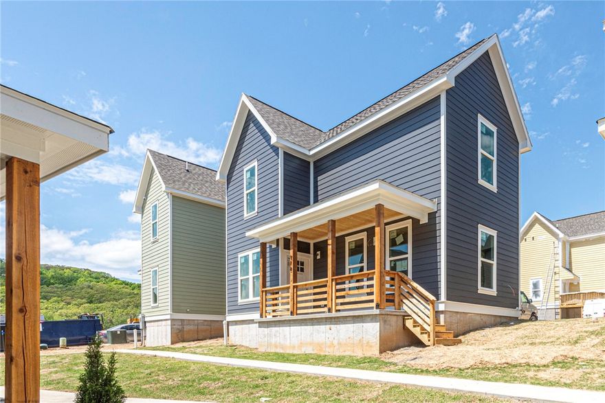 Welcome to Southern Woods! A Trailside Community nestled at the base of Centennial Park (2022 Top Outdoor Facility, Arkansas Parks & Rec) Not only does this location offer access to miles of trails, greenspaces with paved pathways, & bicycle stalls, it is also minutes away from shopping, food, I-49, & University of Arkansas! BENT floor plan feat: a covered front porch with cedar posts, an open concept first floor with 9’ ceilings, large windows for natural light, half bath, LVP floors, & kitchen w 3cm granite counters, subway tile backsplash, large center island with sink, stainless steel appliances, eat-in dining, & back deck! Upstairs: Laundry space & 2 Bedrooms w private ensuites feat tiled frameless glass shower. Perfect for homeowners & investors! POA $35/mo includes ground maintenance, never mow again! Don’t miss out on this one of a kind community in a premier location! Full list of home finishes available. Inquire now!