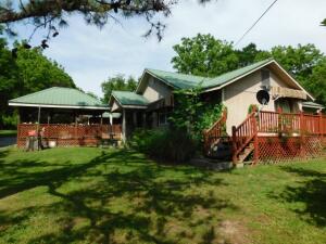 Charming Home with large outdoor Gazebo, detached carport, 30 x 40 ft shop building with concrete floor and 2 overhead doors, 2 storage sheds, approximately 2 acres with Hwy 65 South frontage. Home has front entry, spacious living area with extra den area that ''L's'' beside and opens to dining & kitchen. Office with outside entrance to driveway at back corner of home, or office could be used for 3rd bedroom. Note - will consider selling home with yard only. Note: City of Harrison has access easement along the driveway and to the water tank at north end of property. Multiple Offer Received, seller requests highest and best by 5:00 pm Wednesday 6/15/22.
