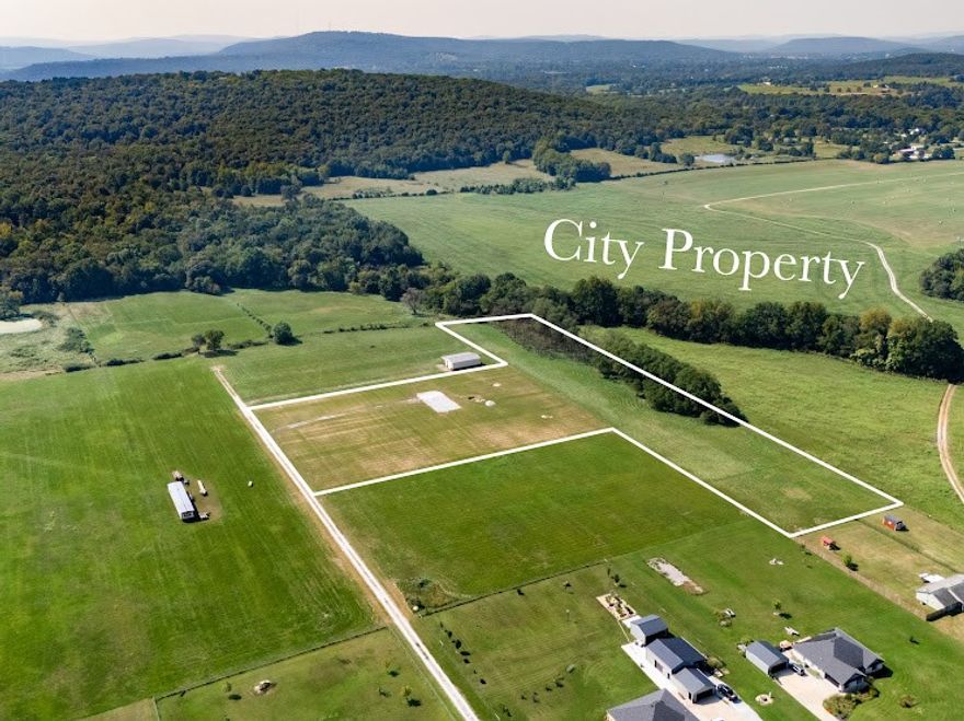 Where convenience and privacy collide - this stunning 6-acre White River Valley estate offers sweeping views, peace and privacy, and endless possibilities without restrictions. Nestled on a quiet, private road, and just 6 miles from the U of A, it's perfect for horse lovers or those wanting room to roam, with 3 fenced acres ready for your animals. 

Adjacent to Fayetteville city farmland and minutes from Lake Sequoyah and White River access, this is your chance to create the forever home you've dreamed of. Perc test available, new water tap needed, septic needed, utilities at street.