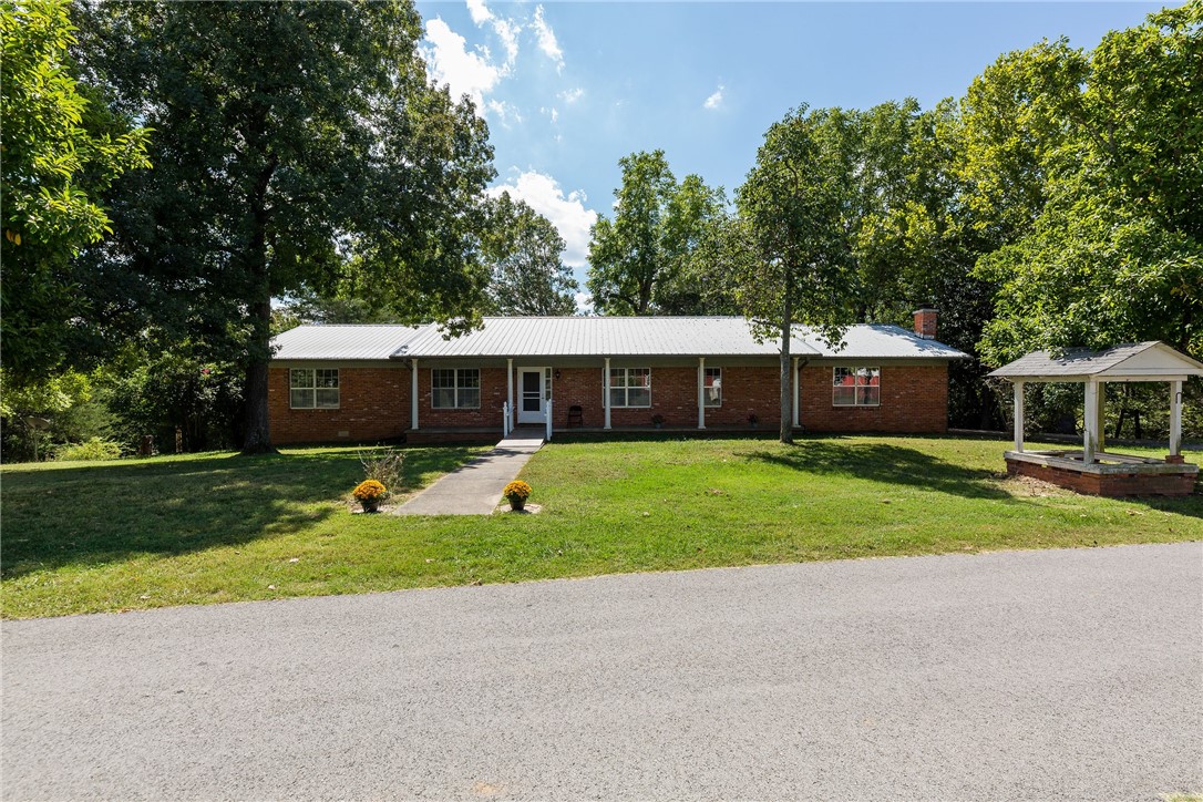 Unique property giving you the privacy of 17+ acres yet living 2 miles from schools, shopping, restaurants, medical, banks etc. Perfect for mini farm, homesteading, multi generational family living, possibility of splitting land or building additional homes with proper application & approval from city/county/utilities. House is older but is in good solid condition, has 2 woodstoves, free standing 4 car garage, huge heated/cooled metal shop, addl storage building, and room over root cellar. 30 x 60 shop has 2 overhead doors and is large enough to store equipment, and suited for hobby shop or possibly a home business with any required permits. Land is mixed open field, and wooded with amazing mature hardwoods, mostly level leading to house/shop then slopes down toward pond. Has ample room for large garden, orchard, and animals. It is buyers responsibility to determine if land can be split, or additional homes built.