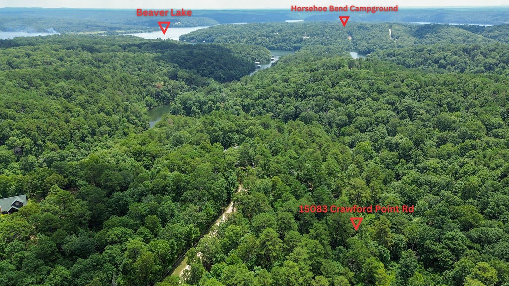 This 5-acre property offers the perfect blend of privacy and convenience, located just minutes from downtown Rogers. With level buildable terrain in the front of the property, it's an excellent opportunity to create your custom home in a peaceful, wooded setting. The land has been surveyed and perc tested for a 3- or 4-bedroom home, saving you time and steps in the building process. Mature trees and abundant wildlife create a secluded feel while keeping you close to town. Schedule a visit to experience the potential for yourself.