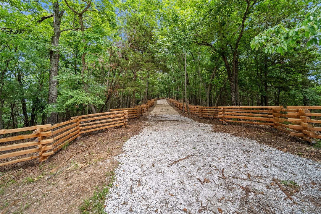 Entrance through the Cedar Split Rail Fence on either side of the road to this Beautiful Lake View 2.68 Acre lot. Stunning year-round views of the main body of Beaver Lake between Point 6 and Point 8 in the Whispering Hills community. The lot has a level build site location over looking the lake, literally a blank canvas for you to dream it and make it your own. Buyer will need to drill a water well and install the septic system. This property features unmatched picturesque views, and there are plenty of options for homesites. Schedule your appointment today to see this Beautiful Lake View Property!