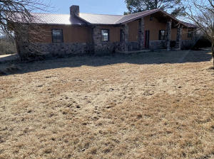 Large open living area with fireplace, 4 bedrooms, 2 1/2 baths on 2.2 acres. 2 car garage, outbuilding.