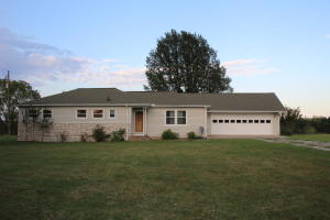 Clean move in ready home with 4 bedrooms and one full bath. Large utility room centrally located with folding table, washer and dryer included. Kitchen with eat in bar area and nice size dinning room. Just off dining room is living room with original oak floors. Large two car garage and plenty of room to add a shop. Home on a well but could hook up to city water. Beautiful views on paved county road and peaceful country setting on 1.8 acres M/L.