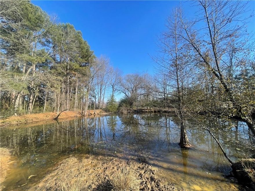 Beautiful 4.25+/- acres of pasture land currently used as a small horse farm, located just outside the Russellville city limits in the highly sought-after Pottsville School District. Conveniently positioned near Russellville, Dardanelle, and Pottsville, this property offers the perfect balance of country living with quick access to town. The land features multiple potential building sites and includes a 30x40 lofted barn with concrete floor, along with a tractor barn and hay shed. A nice-sized, spring-fed pond provides year-round water and adds to the property’s charm and functionality. All utilities at the road, making it ready for your dream home or farm setup. If you’re looking for peaceful country living just minutes from downtown Russellville and downtown Dardanelle, this is truly one of the best locations on the market.