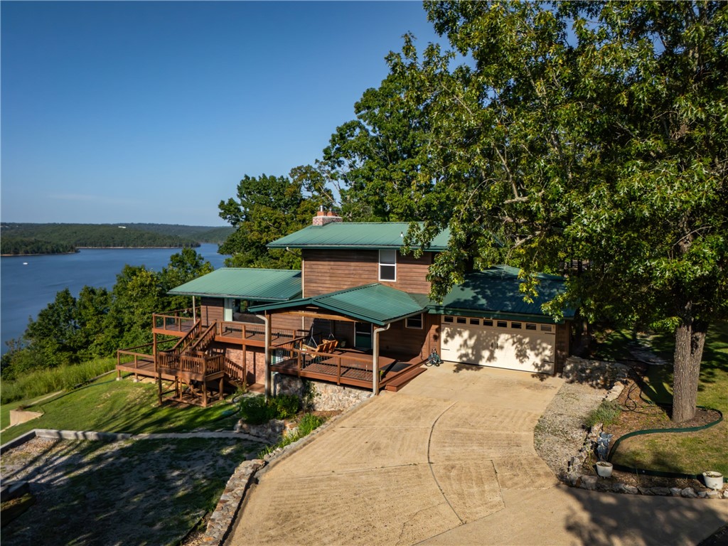 ONE OF THE BEST LAKE VIEWS IN THE COUNTY! Take a look at this 3 bedroom, 3-bathroom home with views of the famous Bull Shoals Lake! This home is clean neat and ready for you to move in! Amazing views from both decks and from inside the home. Basement has its own private bedroom and bathroom. Dual sided fireplace in living room/dining room. Home has had several updates and has a metal roof! If you love to relax, then you have hit the jackpot with this home! Plenty of wildlife, fresh air and peace and quite is what you will find from this front porch! Close to White River Access and Bull Shoals Lake access!