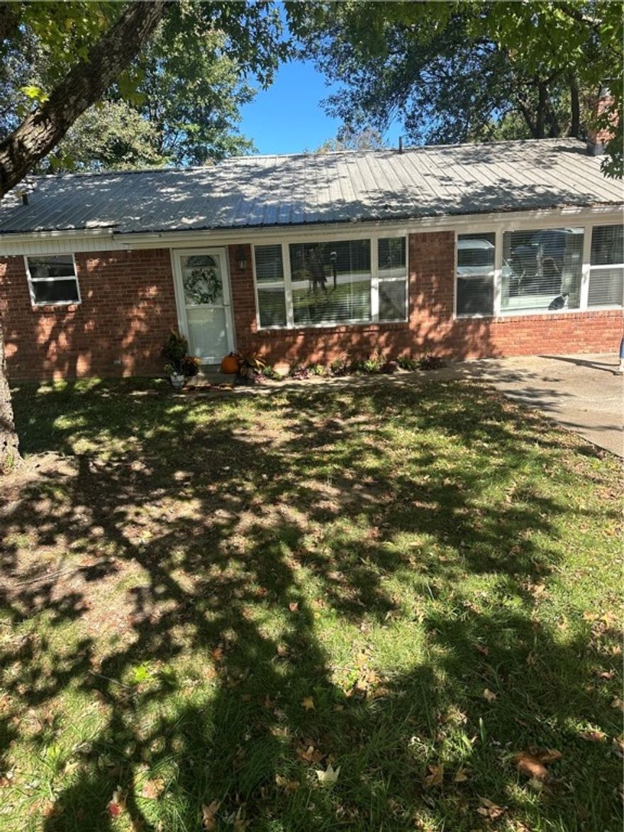 In West Fork, just minutes from Fayetteville, where small town comfort meets convenience. This charming 3 BR and 1.5 BA home is full of updates and ready for you to move in. Inside find a spacious kitchen that opens to an adjoining dining area perfect for family meals or entertaining friends.  The cozy sitting area features a wood-burning stove that keeps heating bills low and adds that warm, inviting touch all winter long. There's also a 2nd living room, offering plenty of space for relaxing. This home saw major upgrades in 2022 including a new metal roof, siding, windows, and doors, along with refinished floors and updated lighting. The kitchen shines with a new stove, microwave dishwasher and garbage disposal.  The mechanicals have all been take care of too; with a new furnace and duct work installed in 2022, a new a/c unit in 2024, and a new wood-burning stove with a metal chimney shaft for efficiency and peace of mind. With all of these updates, this home combines comfort, style , and value all in West Fork.