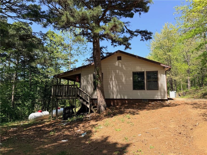 Duplex across from Cliff House Restaurant in Jasper. So many possibilities to make an Airbnb, two small rentals or live in one side and rent out the other side. Covered porch along back side of home. Between Jasper and Deer. Buffalo River nearby. Property will need updating. Selling AS-IS. All numbers approximate. Age and sq ft per Assessor's office.