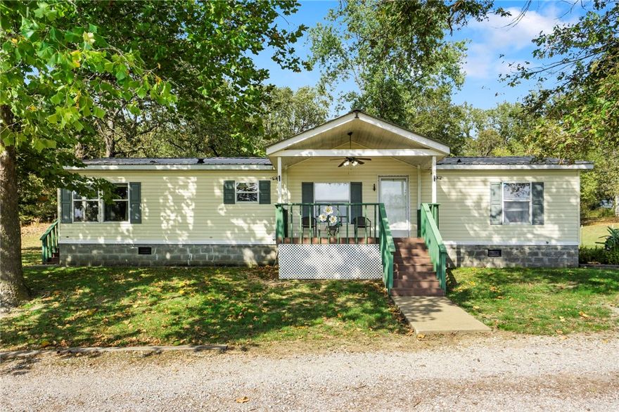 Charming 3+ acre property offering peaceful country living with easy access to Hwy 412—or avoid traffic with scenic back roads! Enjoy a cozy living room with wood-burning stove, a bright eat-in kitchen with stainless appliances, and a spacious primary suite with soaking tub and walk-in shower. Updates include wide-plank flooring, water heater (1 year old), and new water lines to the house and shop/barn. Fenced and cross-fenced with a powered shop/barn ready for projects or livestock. Great setup for horses with plenty of open space, and the covered riding arena is just a short horse ride away. Easy commute to Springdale, Centerton, Rogers, Bentonville, and Siloam Springs—all from your own slice of Arkansas paradise!