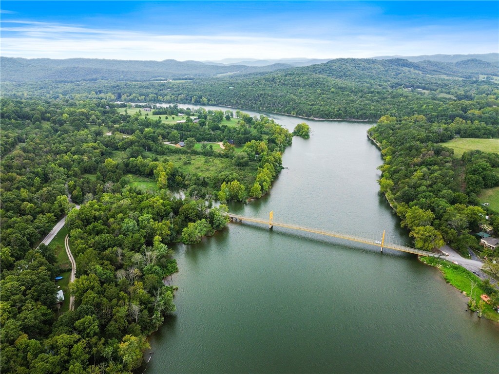 4 wooded acres looking out toward Table Rock Lake, on a mountainside w/fabulous view possible after you decide where you want to build (or not). The exceptional fishing below, directly in front of this property, is only one of the Reasons to choose this serene location. Located close to the charming and much sought after little town of Beaver, with its RV Park, swimming, camping, boat launching, and the famous swingin' Bridge, on the National Register of Historical Places, you will have access to all the nightlife, restaurants, microbreweries, Passion Play etc. in wonderful Eureka Springs. There's even a winery nearby ! Rogers is 40 mi. away with a yummy chocolate stop on the way, and XNA only a few mi. after that. Build your dream house on this waterfront property, or just hold on to it for a while, there's always a reason to own a piece of the Ozarks !