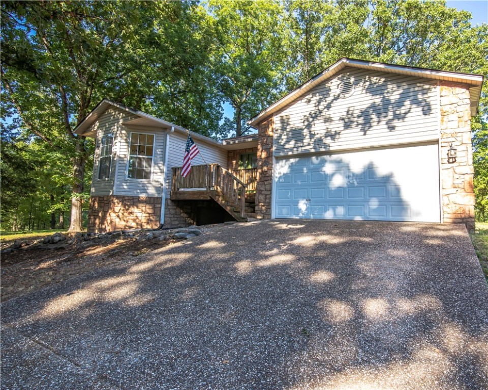 Beautiful corner lot with .44 Acre & mature trees. Very well kept 1,798 SF home with sunroom & deck. 2 Baths, 3 bedrooms all have walk-in closets. This home has new carpet in all bedrooms & fresh paint throughout house & garage. New dishwasher. Refrigerator conveys. New smoke detectors throughout, new garage door opener motor. Propane fireplace in the family room along with vaulted ceilings. Beautiful hardwood flooring in living room & hallway leading to the bedrooms. If available, sewer connections are required. According to Bella Vista city ordinance (Ord. No. 2009-03), if your property is currently connected to a septic tank & sanitary sewer service is available, the property owner is responsible for connecting to the service line provided at the tap-in point on their lot or on the adjoining lot. This requirement applies only upon the sale or transfer of ownership of the property & must be completed within 90 days after the sale or transfer. ***$10,000 in seller concessions to be used at buyer's discretion. ***