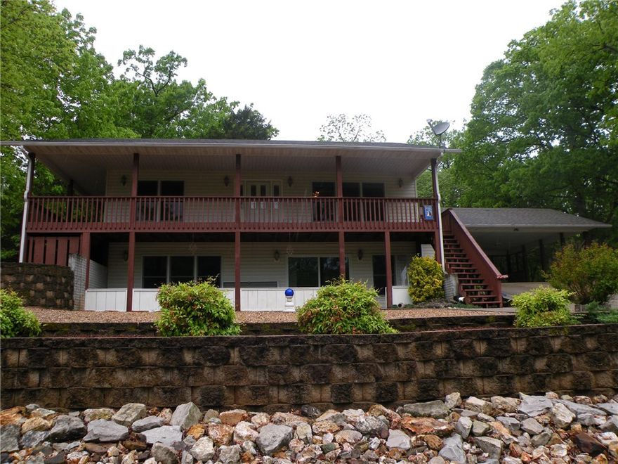 Live across the street from Table Rock Lake. No one can block your view! Low maintenance exterior, easy care landscaping & 36" doors inside.Master & common living areas on main level. Lower level accesses a patio w/lake view. Living room accesses a covered, lake view deck & the kitchen/dining area accesses the back patio that is complete with a hot tub.Wrap around decks & pathways add to property ambiance.Very well maintained home w/upgraded filter on HVAC,newer water heater.Single car garage/workshop/220