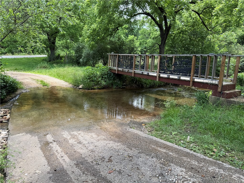 This rock house has on 7.78 beautiful acres with a stream running through it, has much potential with some TLC. 2 br converted to 4 bedrooms, 2 br need vented. New Hickory Cabinets in the kitchen to include a propane stove. Property on a well. Bathrooms have been remodeled, main bathroom set up for stackable washer/dryer, and a second bathroom was added to primary with walkin shower. New flooring in kitchen and living. Large living room with wood stove. Property partially fenced. There is a chicken coop, garden shed, cellar, a detached garage with additional storage and washer/ dryer hook up. Plumbing has been redone in 2023. Well is in cellar and has water softener. Metal roof aprox 9 yrs old. Water heater 2 yrs old, HVAC age unknown. New sediment trap.