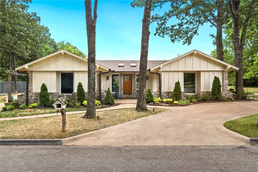 This lovely home is located near all of the amazing amenities Northwest Arkansas has to offer. Nestled on over half an acre with an additional lot in an established neighborhood, this home has 5 bedrooms, 3.5 bathrooms and an additional room with its own lounging area, built-in bunks and new carpet. The completely remodeled primary en-suite was designed by interior designer, Chris Goddard. Host family and friends or lounge indoors with compliments of a Sonos sound speaker and stone fireplace. A large kitchen includes state of the art appliances, space to gather around the island and a seating area with an ample amount of natural light. The expansive backyard is an entertainer's dream featuring a saltwater pool, lit tennis courts with pickleball and basketball, outdoor shower, dining area, and a fire pit. This home is luxurious and comfortable, all while being in close proximity to the Walmart Amp, Crystal Bridges Museum, the Razorback Greenway trail, and more!