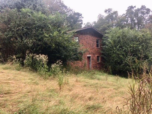 FIX and FLIP! Brick house with fireplace on .53 acre lot with additional .87 acre lot included. Area homes are nice. This house needs pretty much everything. use extreme caution while entering this property. Floors are soft and there could be possible mold. Do not enter property without an agent present. Seller and listing firm are not responsible for harm to individuals entering property. Property sold “as is” submit offers through 4:00pm Fri 10/25/10