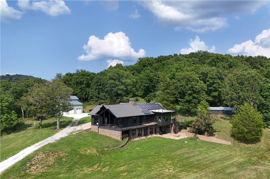 Discover this luxurious retreat on 224+/- acres of prime pasture/timber/hunting land in the Ozarks. This property is a paradise for the outdoor lifestyle, horseback riders, wildlife enthusiasts and hunters. A stunning 3,865 sq ft contemporary home boasts plenty of natural sunlight with the floor to ceiling windows throughout. A new master addition was completed a year ago adding more room for all.  Enjoy cooking in the gourmet kitchen with 2 sinks and pot filler. Designer touches and finishes throughout.  Home has fiber optic internet and is energy efficient with a Geothermal system and solar. This resort style property also has a private 7-acre stocked lake.  Experience the tranquility of rural living with the convenience of nearby amenities.  Nestled in the scenic countryside of Winslow, Arkansas. All this combined, makes this property an unparalleled blend of comfort and adventure.