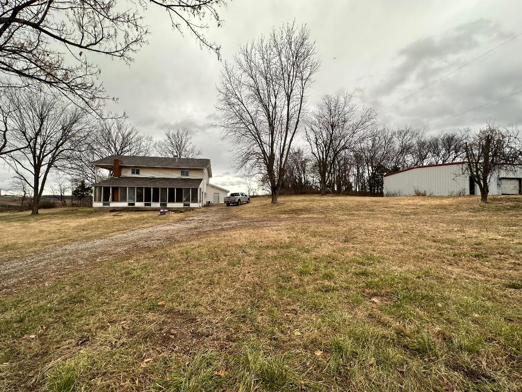 Bring the chickens and the livestock! Wonderful investment property with some very useable fenced acreage just minutes from highway 65 and Alpena. Rolling hills and open views boasted from the land of this home. Native grasses of predominately Bermuda, red & white clover, and fescue. With 6 bedrooms and 3 full bathrooms, two of the upstairs bedrooms offer a covered balcony over looking farmland laying on the banks of Long Creek. Gorgeous sunroom with fireplace just waiting for all those plants or a pool table and tv to watch those ball games! The home also offers a 30X100 metal red iron shop building with concrete floors and partially insulated. The 100x14 chicken coop with perfect breeder pens for poultry or rabbits is just waiting to get put to use!