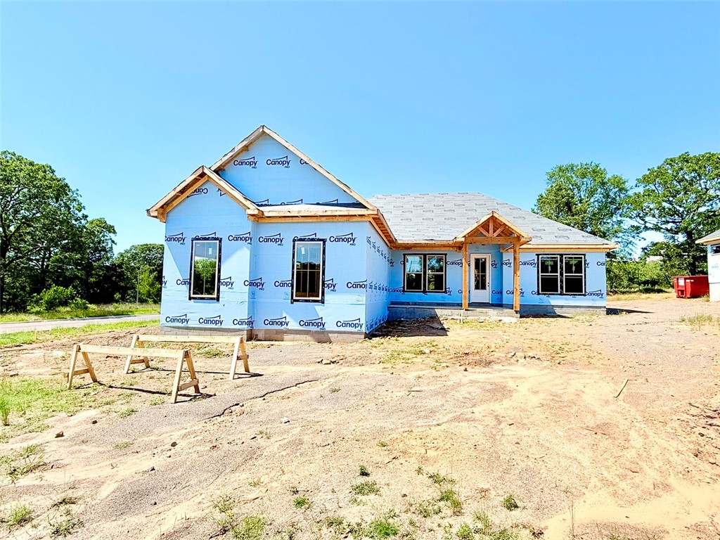 Currently under construction, photo is for information only, colors can possibly be different. Lot 27 on Elk Horn in Scenic Way Village is a 2,047 square foot new construction home situated on a 0.32-acre corner lot. This thoughtfully designed home features 4 bedrooms, 2.5 bathrooms, and a 2-car garage. The open-concept layout begins at the entryway, leading into a spacious living room with a fireplace and a connected kitchen and dining area. Off the kitchen is a walk-in pantry and a conveniently located half bath. The primary suite is privately tucked away, featuring a walk-in closet that connects directly to the utility room for added convenience. One of the bedrooms offers flexibility for use as a home office or study. A covered back porch provides a great space for outdoor relaxation. Scenic Way Village is located just one mile from Lake Dardanelle State Park and offers quick access to outdoor recreation, downtown Russellville, and local amenities.
