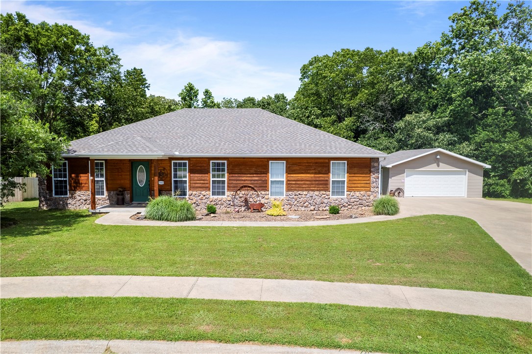 Looking for Extra Outdoor Space? Wrapped with a gorgeous treeline to enjoy the Ozarks Beauty, this well maintained 3/2 has and extra lot for a total of .87acres and a 24x24 detached garage. Grab a cup of coffee and enjoy nature from the covered back deck. Open concept with Beautiful gas log fireplace. Growing town with several new businesses. Just minutes to WM Home office, 549 and Beaver Lake. Don't Miss This One. WELCOME HOME!!