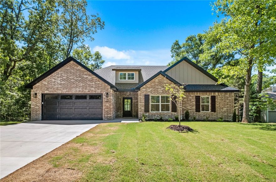 New construction on a large .39 acre wooded lot down the street from the Flo Ride Trail Crossing and provies easy access to Lake Ann! Step inside to discover an inviting open concept design featuring beautiful floors that enhance the spacious feel of the home. The stylish kitchen is equipped with a gas range, 3 cm quartz countertops, custom cabinets, and a walk-in pantry. Entertain or unwind in the living area, complete with a stunning fireplace, or step out onto the HUGE COVERED PATIO to enjoy the peaceful surroundings. The primary suite features a large walk-in tile shower and closet. Bentonville schools! Buyer can receive $3,500 in closing costs when using the builder's preferred lender!