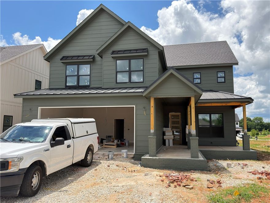 Welcome to your new home in the best location in NWA! This floorplan features 4 bedrooms (primary down & 3 up), study, large living and kitchen area, and 3.5 baths. Lots of storage and built-ins throughout the home. Large kitchen opens to living room with access to back patio. Primary suite is downstairs with soaking tub, large walk-in shower with dual shower heads, oversized vanity with dual sinks, and spacious closet! Upstairs you will find 3 bedrooms and 2 full bathrooms. Back covered patio makes a great place to grill and hang out. Enjoy the Meadow Brook playground or just across Bellview is the Razorback Greenway Trail!
