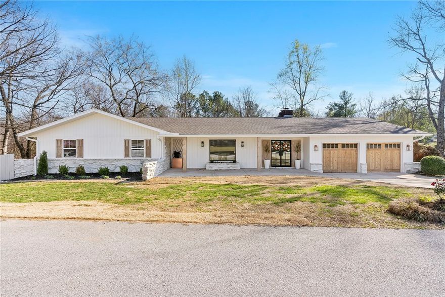 This beautiful 5104 sqft residence on half of an acre has undergone a complete transformation, leaving no expense spared to create a sanctuary of luxury and comfort. Nestled on a cul-de-sac street in a quiet neighborhood less than 1.5 miles away from all that downtown Rogers and Lake Atalanta have to offer, this meticulously remodeled property offers tranquility, friendly neighbors, and convenience to both city amenities and nature. With an open floor plan, 5 bedrooms, 4.5 bathrooms, media room, workroom, spacious walkout basement, and expansive deck this home has plenty of space for your whole family. The kitchen boasts a 48" double oven dual-fuel range, workstation sink, coffee nook, and pantry with built-in storage. The primary ensuite has a walk-in shower, soaking tub, double vanity, and a large closet with built-ins and vanity area. Downstairs you are welcomed to a walkout basement with kitchenette and second living area with wood-burning fireplace. Close to Haas Hall, Arkansas Arts Academy, and Railyard Park.