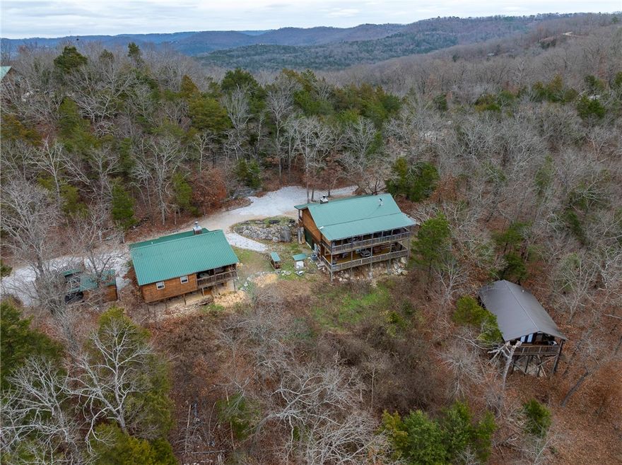 Beautiful 3-acre estate overlooking Inspiration Point and the White River, just minutes from Eureka Springs. This rare property includes two custom all-wood homes and an ADU.
The main house is a two-story 3 bed, 2.5 bath with an office, bonus room, and a two-level deck, built to highlight the surrounding landscape.
The second home is a comfortable single-story 2 bed, 2 bath with an office, perfect for extended family, guests, or long-term rental use. Like the main home, it offers quality wood craftsmanship and a peaceful setting.
The ADU is a fully furnished studio currently operating as a successful short-term rental, with bookings already secured for 2026, providing instant income.
With unmatched views, three separate dwellings, and incredible versatility, this property is ideal as a family compound, private getaway, or high-performing investment opportunity in one of the most scenic areas of the Ozarks.
Reach out for 3D tours of all three properties and additional property details and descriptions!