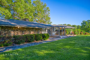 Designed Before it's Time! This beautiful custom built 4 bedroom, 4 bath home is timeless! You will fall in love with the unique accents and the wonderful deck from which you can relax and enjoy the views! Other features include an open floor plan, cathedral ceiling, large skylights, large natural stone fireplace with gas insert, central vacuum, natural wood & beamed ceilings, all appliances including two washer & dryer sets and deep freezer. The basement includes a large family room, bedroom, full bath workshop area, additional laundry room, drive in garage and more.This home has been admired by many! And now it can be yours!