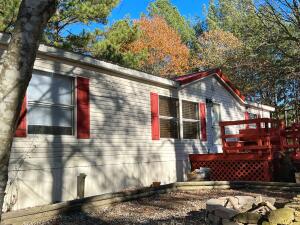 Take a look at this 3 bedroom, 2 bathroom split floor plan double wide manufactured home. This home features open and spacious living areas and a roomy master bedroom with a nice size closet and bathroom. The property is made up of 3+ beautiful acres with mature trees and plenty of space between neighbors. Here you can enjoy your morning coffee on the front deck or back deck. There is an outbuilding with a small coop for chickens or other small animals. This is a great spot to relax and enjoy the quiet life of the country. Call for your showing today! $3,000 flooring allowance