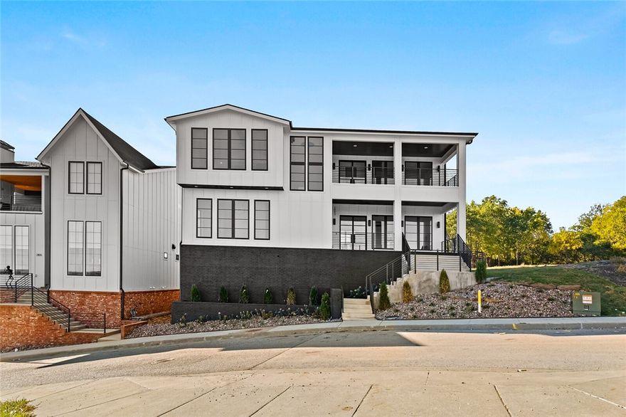 Welcome home to the Pinnacle at Mission Heights. This home is an entertainers dream. Main level has an open floor plan where the double islands in the kitchen flow effortlessly into the living room. Kitchen has a chefs lineup of appliances with a 48" dual fuel dacor range, Built-in chef refrigerator/freezer, miele dishwasher, and commercial ventilation. Living room has 3 sets of iron and glass french doors allowing for entertaining on the front or back covered patios. Travel upstairs and the views will literally take your breath away. The primary bedroom is incredibly spacious with vaulted ceilings, faux beams, one of the largest custom barn doors in NWA, and its own wet bar. The Primary bath is on a whole different level. Wall mount Rohl faucets, extended double vanity, large solid surface soaking tub, and huge walk in double shower. Media room, extended Primary closet/nursery/office, and one additional bedroom are also on the top level. You won't want to miss the opportunity to see this house.