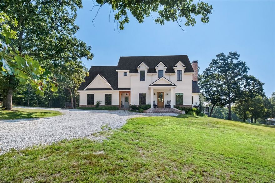 Stunning country estate featuring a 3661 square foot craftsman farmhouse sitting on 53.45 rolling acres with a fully stocked pond. Custom built in 2019 with great attention to detail, including designer lighting and smooth drywall. An abundance of natural light flows from formal dining with barn doors to living room with vaulted ceiling & wood burning fireplace. Gourmet kitchen with island & separate full pantry. Enter from friend’s entry or 3 car garage into mud area with built-in cubbies & utility room with drying shelves & dutch door. Private main level primary bedroom with elegant bathroom & walk-in closet. Upstairs features 3 bedrooms, 1 ensuite bath, 1 Hollywood with double sinks, bonus room with built-ins, and attic storage. Incredible covered back porch with swing & nightly views of wildlife. New in-ground pool. Home generator, security system with cameras, central vac. Custom barn with mini split system could easily be finished for guest quarters. Additional well on property.