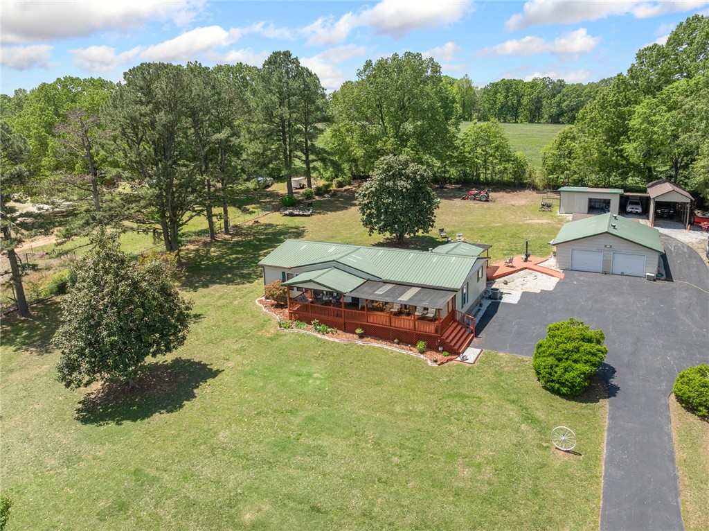 Beautiful home with 2.25 acres, well manicured in a great area just outside the city limits. The covered front porch runs the length of the house, plus a covered back deck provides a great space to enjoy the peaceful setting outdoors. Well cared for 3 bedroom 2 bath sits on a permanent foundation surrounded by mature trees.Ā Outbuildings are abundant and provide an extra 1600 square feet of storage with a 28x30 detached garage, a 16x24 pole barn with lean-to and 3 additional outbuildings.