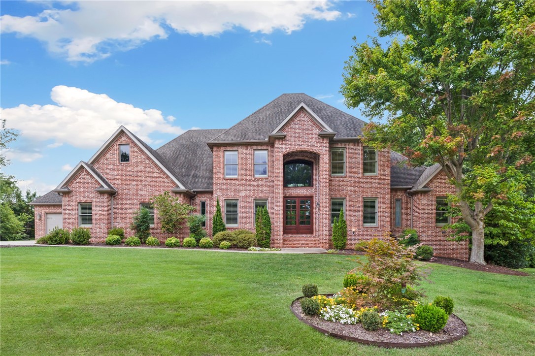 This updated estate in prestigious Pinnacle Country Club offers 6,467 sq ft on nearly an acre at the end of a quiet cul-de-sac. Designed for comfort and entertaining, it includes 5 bedrooms, 4 full and 2 half bathrooms, a living room with fireplace, formal dining, office, and multiple living areas across three levels. The gourmet kitchen features new granite countertops & backsplash, pot filler, painted cabinetry, upgraded lighting, built-in refrigerator/freezer, and a large walk-in pantry. The primary suite offers a spa-like bath and expansive closet, while upstairs includes two en suite bedrooms and a second living area. The walk-out basement adds a full entertainment space with second kitchen, media room, exercise, flex room, and 1,100+ sq ft of storage with tornado shelter. Updates include a custom 2024 pool with heater/cooler, new irrigation and landscaping, refinished hardwoods, fresh paint, and new lighting. A screened porch and oversized 4-car garage complete this Bentonville Schools home.