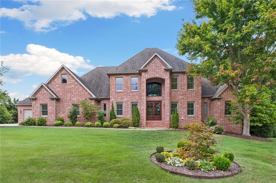 This updated estate in prestigious Pinnacle Country Club offers 6,467 sq ft on nearly an acre at the end of a quiet cul-de-sac. Designed for comfort and entertaining, it includes 5 bedrooms, 4 full and 2 half bathrooms, a living room with fireplace, formal dining, office, and multiple living areas across three levels. The gourmet kitchen features new granite countertops & backsplash, pot filler, painted cabinetry, upgraded lighting, built-in refrigerator/freezer, and a large walk-in pantry. The primary suite offers a spa-like bath and expansive closet, while upstairs includes two en suite bedrooms and a second living area. The walk-out basement adds a full entertainment space with second kitchen, media room, exercise, flex room, and 1,100+ sq ft of storage with tornado shelter. Updates include a custom 2024 pool with heater/cooler, new irrigation and landscaping, refinished hardwoods, fresh paint, and new lighting. A screened porch and oversized 4-car garage complete this Bentonville Schools home.