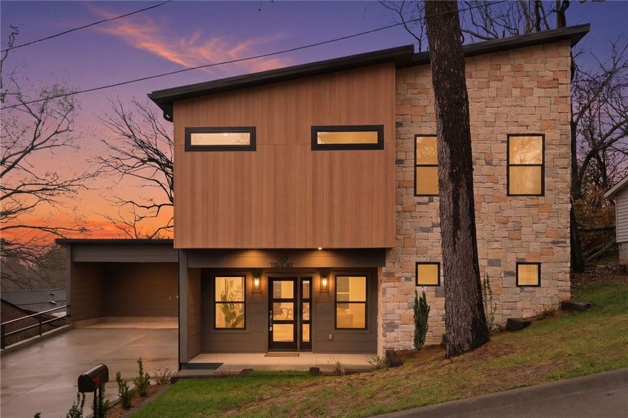 This home offers luxury-forward expression of  urban living in one of Fayetteville’s most vibrant, high-demand areas. A brand-new backyard and  privacy wall create a polished outdoor escape with a clean, architectural feel. The home has a bright, seamless layout that flows into a contemporary kitchen with, granite counters, & stainless appliances, giving the main level an upscale presence. A half bath adds convenience on the main floor. The primary suite elevates the experience with sweeping views, natural light, a walk-in closet, and a modern bath. An additional full bath with a double vanity supports three secondary bedrooms, offering versatility for guests, work, or multi-use living. Located near the University of Arkansas, Dickson Street, trails, & Fayetteville’s most energetic spots appeals to buyers seeking elegance paired with city energy, while also making it a strong opportunity for investors targeting rental and appreciation potential. A $3,000 builder credit is available when using the preferred lender.